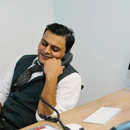 A specialist smiling on a phone call