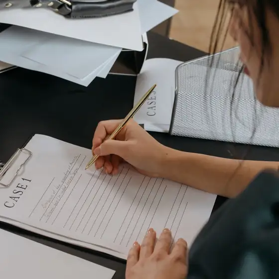 A credentialing specialist filling in enrollment paperwork