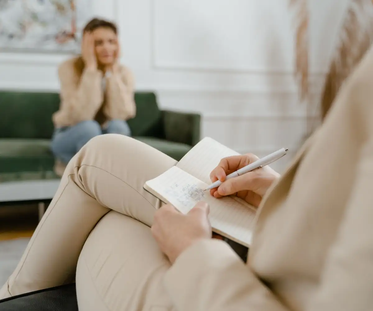 A therapist taking notes during a session